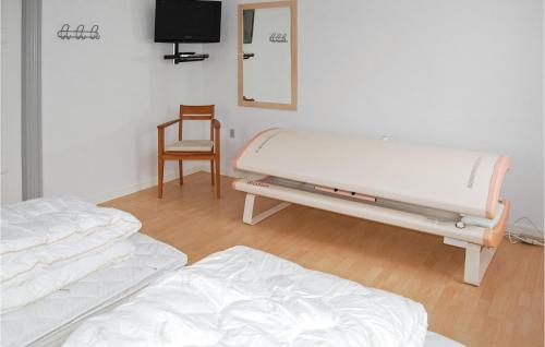 a hospital room with two beds and a tv at Seven-Bedroom Holiday Home In Bredebro in Bredebro