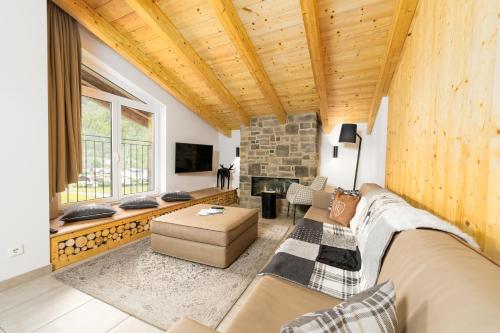 a living room with a couch and a fireplace at AvenidA Panorama Suites in Kaprun