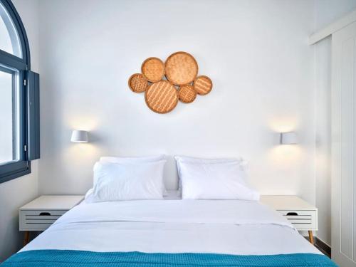 a bedroom with a white bed and two white tables at Jasmine House in Kampos Paros