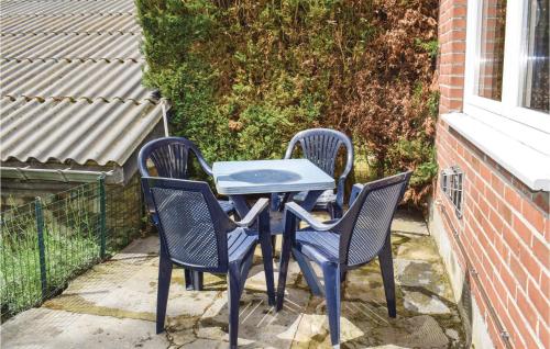 a blue table and chairs on a patio at Holiday Home Lierneux 209 in Lierneux