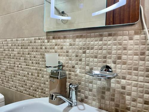 a bathroom with a sink and a mirror at Luxury Cottage next to observatory in Byurakan