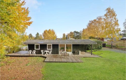 a house with a deck and a yard at Holiday Home Græsted With Fireplace 02 in Græsted