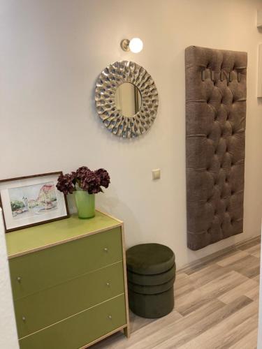 a room with a green dresser and a mirror at Comfy Camel Apartment in Budapest