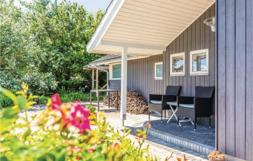 a house with a porch with chairs and a table at Amazing Home In Slagelse With Kitchen in Slagelse