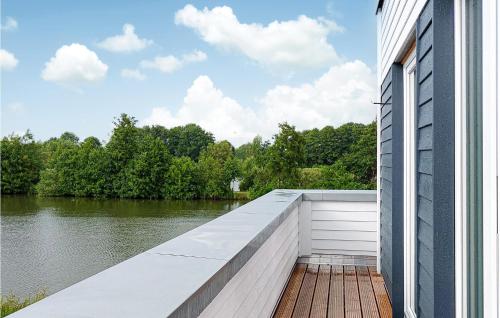 a building with a dock next to a river at Nice Home In Tossens With Kitchen in Tossenserdeich