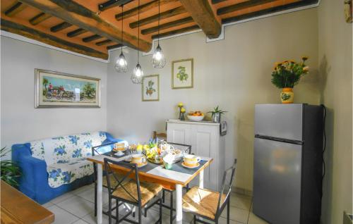 a kitchen with a table and a refrigerator at Awesome Home In Macchino With Kitchen in Marliana