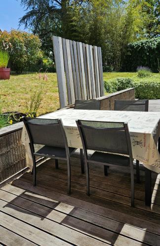 a table and two chairs sitting on a deck at Appartement 1 Maison Régis in Conques-en-Rouergue