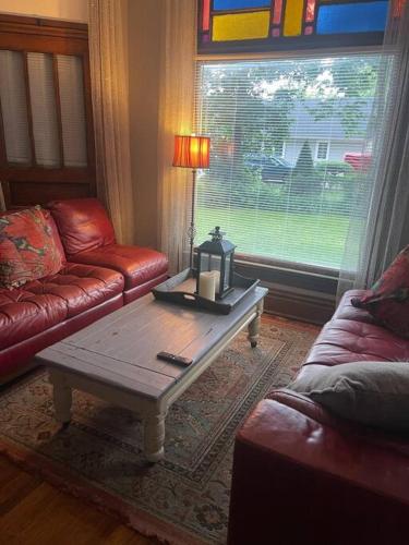 a living room with a couch and a coffee table at 19 century Victorian Home in Des Moines