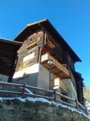 a building with boxes on the side of it at Chalet 3 pièces de caractère in Mayoux