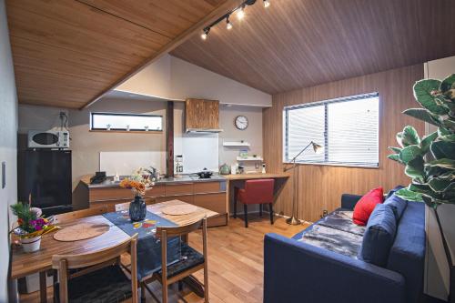 a kitchen and living room with a table and a couch at Tabitaime-Kinohana - Vacation STAY 16308 in Osaka