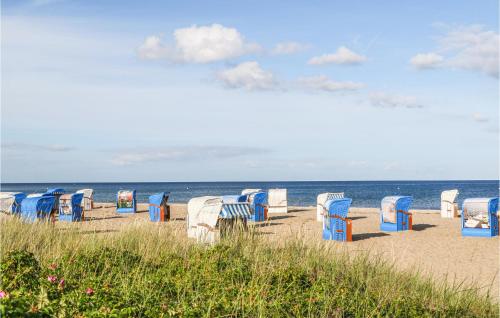 a bunch of chairs sitting on the beach at Bi De Mar in Olpenitz