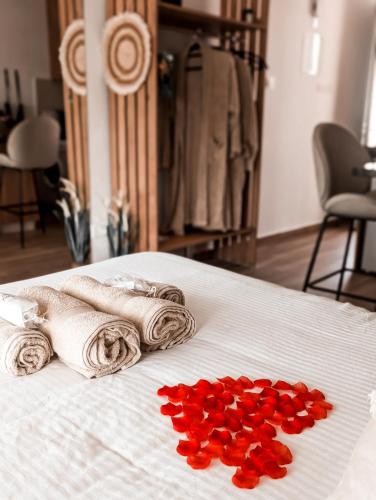 a bed with two towels and red hearts on it at Bohemian Rhapsody in Paphos