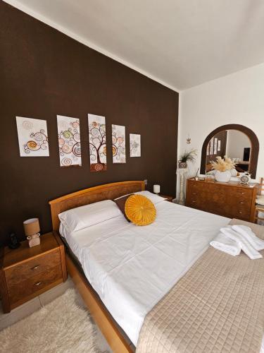 a bedroom with a bed with a yellow pillow on it at La Casa nel Paesello in Portocannone