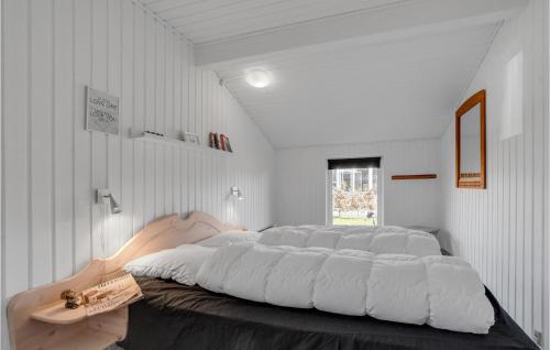 a large white bedroom with a large bed in it at St Croix in Hadsund