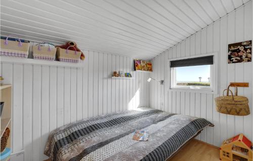 a bedroom with a bed in a room with a window at St Croix in Hadsund