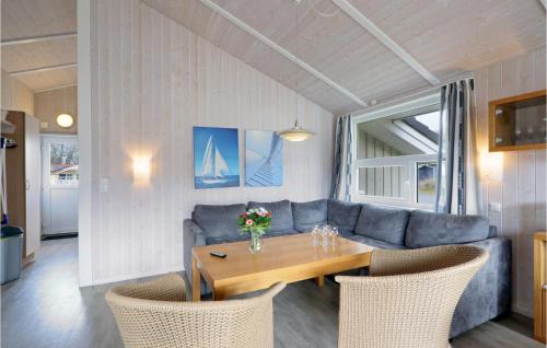 a living room with a table and a couch at Frische Brise 18 - Dorf 3 in Priwall