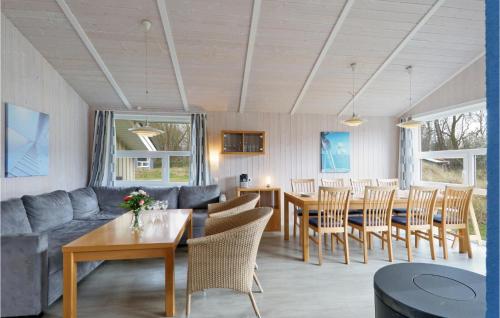 a living room with a couch and a table and chairs at Frische Brise 18 - Dorf 3 in Priwall