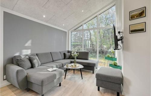a living room with a couch and a table at Nice Home In Hurup Thy With Wifi in Sindrup
