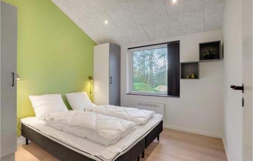a large bed in a room with a window at Nice Home In Hurup Thy With Wifi in Sindrup