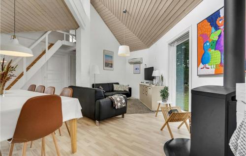 a dining room and living room with a table and chairs at Awesome Home In Fårvang With Sauna in Fårvang