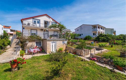 a house on top of a hill with a yard at 3 Bedroom Amazing Apartment In Jasenice in Jasenice