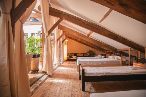 two beds in a room with wooden beams at Villa Bet Loc 14 personnes in Saubrigues