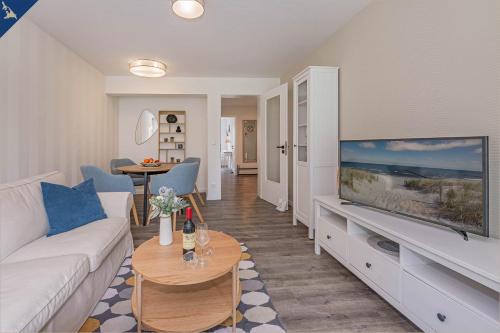 a living room with a couch and a large flat screen tv at Ferienwohnung Lieblingseck in Bansin
