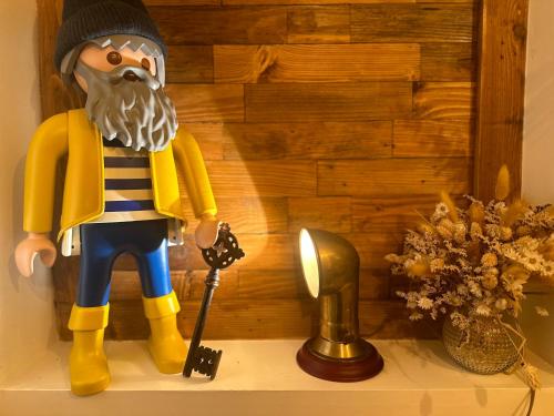 a lego man figurine sitting on top of a shelf at La Clé de Taulé in Taulé