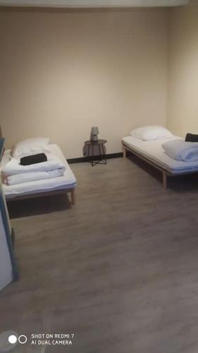 - une chambre avec 2 lits dans une chambre avec une table dans l'établissement charmante maison de bourg, à Francueil