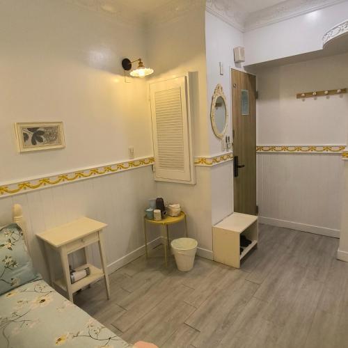 a room with a bed and a table and a mirror at 橙舍二館 TW Hostel 2 in Taipei