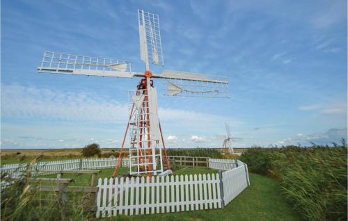 a windmill on top of a white fence at Three-Bedroom Holiday Home In Bredebro in Ballum