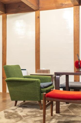 a room with two chairs and a table at Popotel 2 KURA in Matsumoto