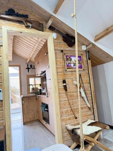 a room with a swing in a tiny house at Storm Cottage in the Countryside in Parczów