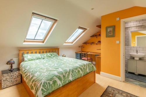 a bedroom with a bed and a bathroom with a sink at 3BR Apt 5 min to BrightonStation in Brighton & Hove