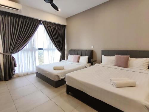 a bedroom with two beds and a large window at Bell Suite Sepang Kota Warisan by DH in Sepang