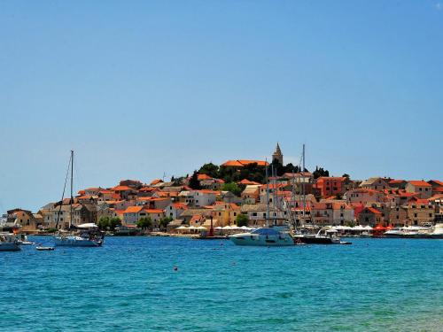 a group of boats in the water near a city at Apartment Josip in Primošten