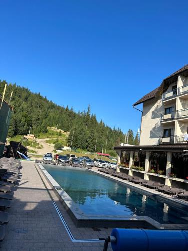 a large swimming pool in front of a building at Continental SPA Resort in Bukovel