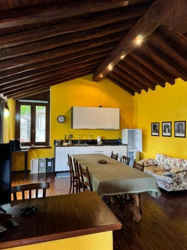 a kitchen and dining room with a table and chairs at La Casa di Nina - Traves in Pessinetto