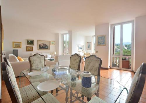 a living room with a glass table and chairs at Caprera Flexyrent NO air conditioning - Seafront in Santa Margherita Ligure