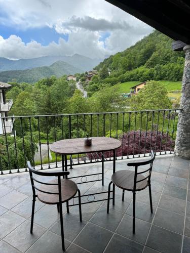 a table and chairs on a balcony with a view at La Casa di Nina - Traves in Pessinetto