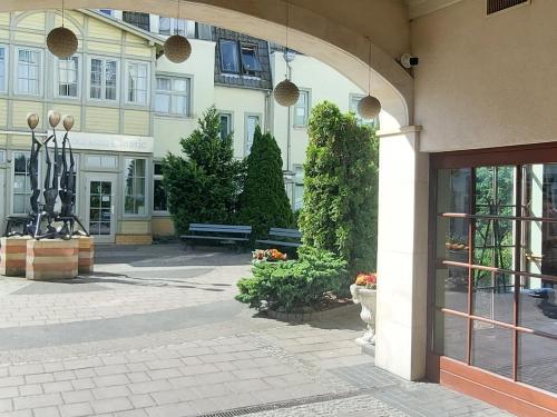 an entrance to a building with a bench in a courtyard at JM Sopot Apartament Monte in Sopot