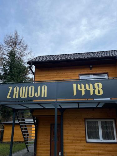 a building with a clock on the front of it at Gnapówka in Zawoja