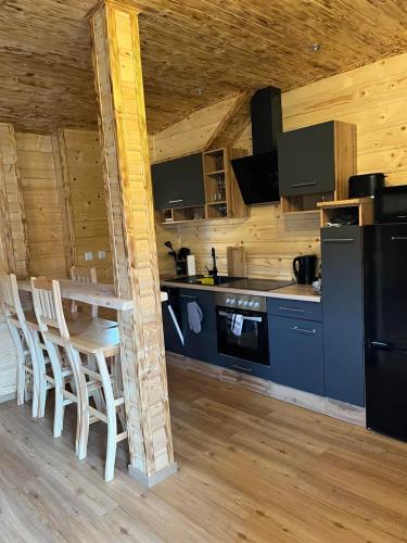 a kitchen with a table and chairs in a cabin at Gnapówka in Zawoja