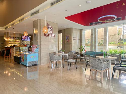 a restaurant with tables and chairs in a room at Swiss-Belhotel Bogor in Bogor