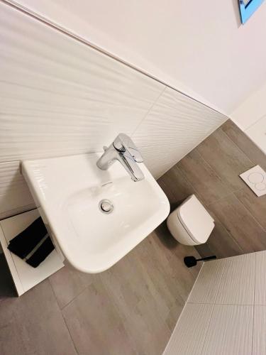 a bathroom with a sink and a toilet at Weikersheim Penthouse in Weikersheim