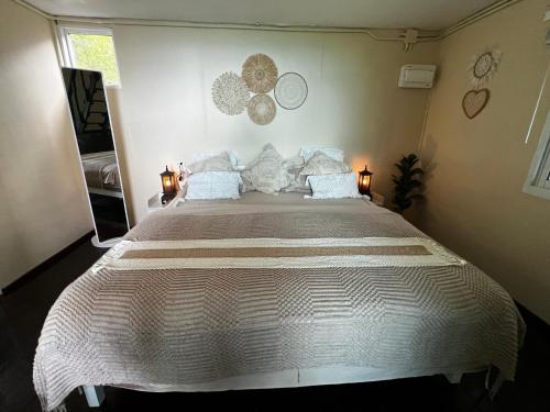 a large white bed in a bedroom with two lamps at The Hidden Gem Viewpoint Camping & Rooms in Ban Nok