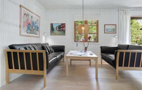 a living room with a couch and a table at Dueodde Ferieby in Neksø