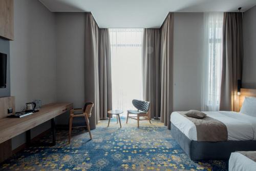 Кровать или кровати в номере Qazaq Hotel Premium