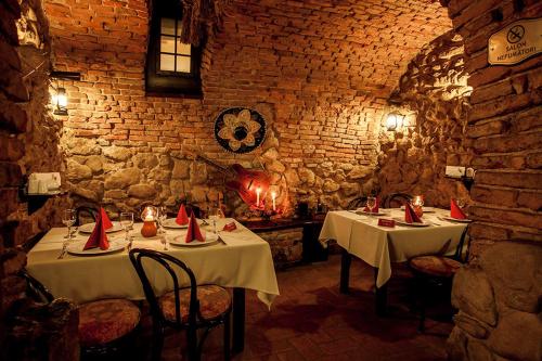 a restaurant with two tables with red napkins on them at Hotel Bella Muzica in Braşov