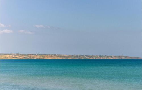 a large body of water with an island in the distance at Segesta in Case Campanella